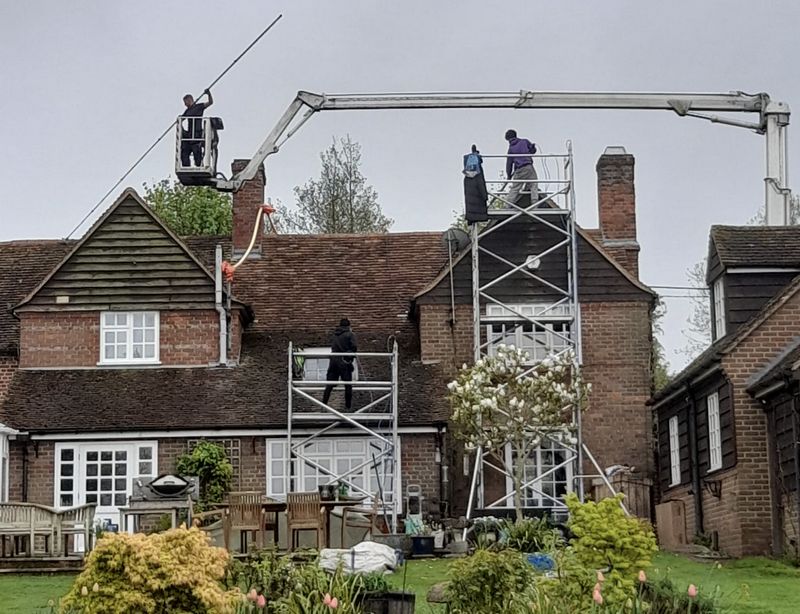 The Moss Cleaners using cherry picker and scaffolding to clean roof safely and professionally in 2A Lion Rd, Twickenham TW1 4JQ, UK, 2A Lion Rd, Twickenham TW1 4JQ, UK